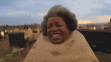 a woman wearing a tortilla on her head is smiling