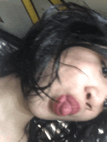 a close up of a woman 's face with a pink lip