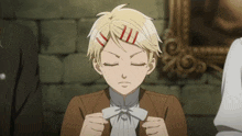 a boy with a bow tie is making a face