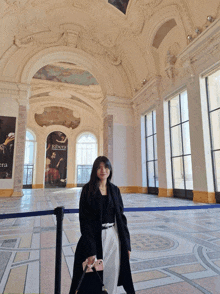 a woman stands in front of a sign that says ribera on it
