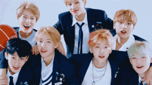 a group of young men are posing for a picture and one has a name tag that says nct dream on it