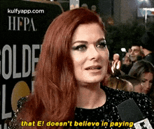 a woman with red hair is talking into a microphone and says `` that el does n't believe in paying . ''