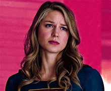 a close up of a woman wearing a supergirl shirt