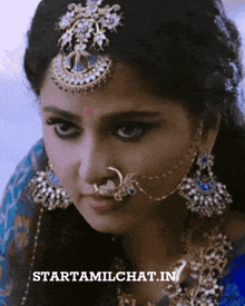 a close up of a woman 's face with the website starttamilchat.in written below her