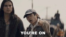 a man pointing at another man with the words " you 're on " below him