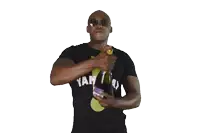 a man wearing a black shirt that says y on it is opening a bottle of wine