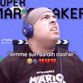 a man wearing headphones and a shirt that says " mario "