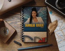 a notebook with a picture of a woman and the name jamilia grier show