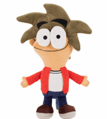 a stuffed cartoon character with big eyes is sitting on a white surface