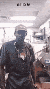 a man wearing an apron and a hat is standing in a kitchen with the word arise behind him