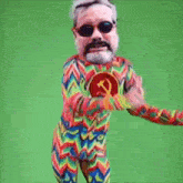 a man with a hammer and sickle on his chest is wearing a colorful outfit