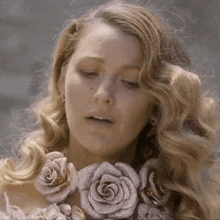 a close up of a woman wearing a necklace of roses
