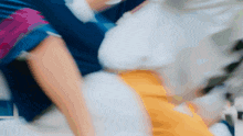 a blurry picture of a person holding another person 's waist