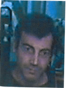 a blurry picture of a man 's face in a blue frame