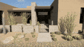 a rendering of a house with a gate and cactus