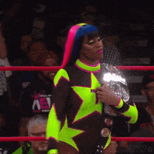 a woman in a wrestling ring holding a championship belt