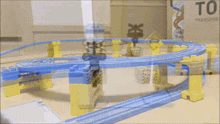 a toy train track with a sign that says priority