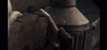 a close up of a person 's hand on a wall next to a lamp post .