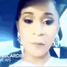 a close up of a woman 's face with the words ngcardib news visible