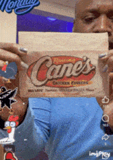 a man is holding up a cane 's chicken fingers sticker