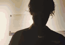 a silhouette of a person with a nike logo on their shirt