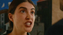 a close up of a woman 's face with a blurred background .