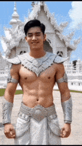 a shirtless man is standing in front of a white building