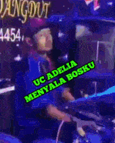 a man playing drums with the words uc adelia menyala bosku on the bottom