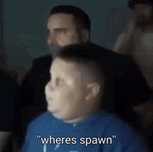 a boy in a blue shirt says " where spawn " in front of a man