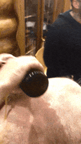 a close up of a person 's hand holding a black object