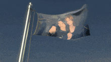a flag with a picture of two women flying in the wind