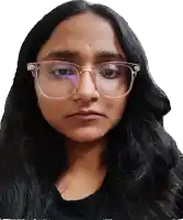 a woman wearing clear glasses and a black shirt looks at the camera