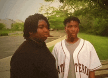 two men standing next to each other one wearing a jersey that says tero on it