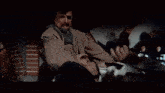 a blurry picture of a man holding a baby and the words spare him