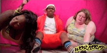 a man and two women are sitting in front of a pink wall with jaster dolphins worlds written on the bottom