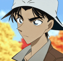 a young man wearing a baseball cap and a jacket