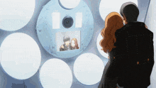 a man and a woman are looking at a picture of a man and a woman