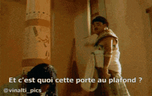 a man standing next to a woman in a room with the words et c'est quoi cette porte au plafond
