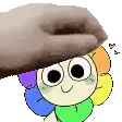 a cartoon character with a rainbow of colors on his face is being touched by a person .