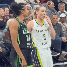 a female basketball player wearing a jersey that says wings