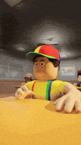a cartoon character sitting at a table with a colorful hat on