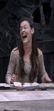 a woman is laughing while playing a game