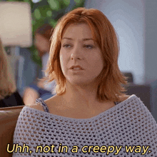 a woman says uhh not in a creepy way while wearing a sweater