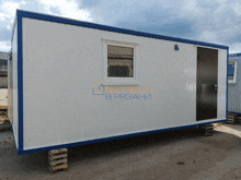a white and blue building with a window and a door that says " lg " on it
