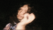 a blurred image of a person 's face with a few spots of light on it