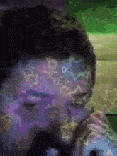 a blurry picture of a person with stars on their face