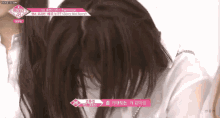 a close up of a woman covering her face with her hands .