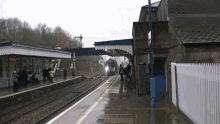 a train is coming down the tracks at a station