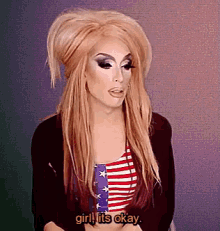 a drag queen says " girl it 's okay " while wearing an american flag shirt
