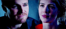 a man and a woman are looking at each other with their eyes closed .